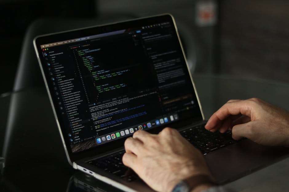 Close-up image of a computer screen displaying lines of code with syntax highlighting, including keywords like 'validates', 'email', and 'has_many' on a dark background, representing programming or so